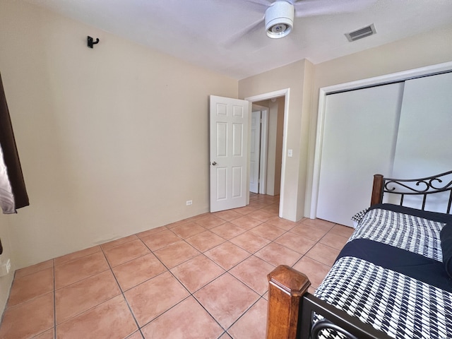 tiled bedroom with a closet and ceiling fan