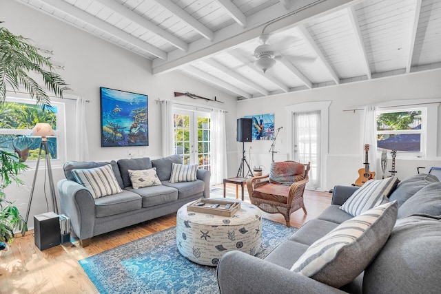 living room featuring hardwood / wood-style floors, vaulted ceiling with beams, french doors, and ceiling fan