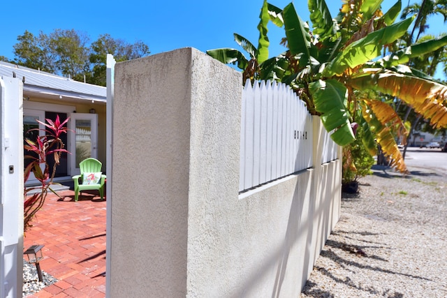 exterior details featuring fence and stucco siding