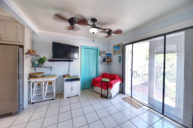 interior space featuring light tile patterned floors and a ceiling fan