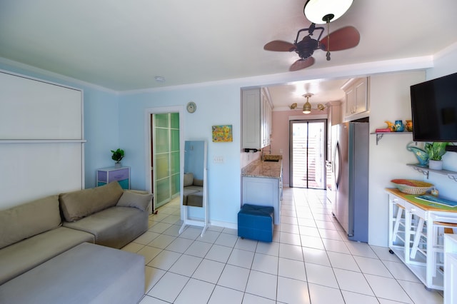 living area with light tile patterned floors and ceiling fan