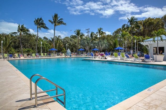 community pool featuring a patio area and fence