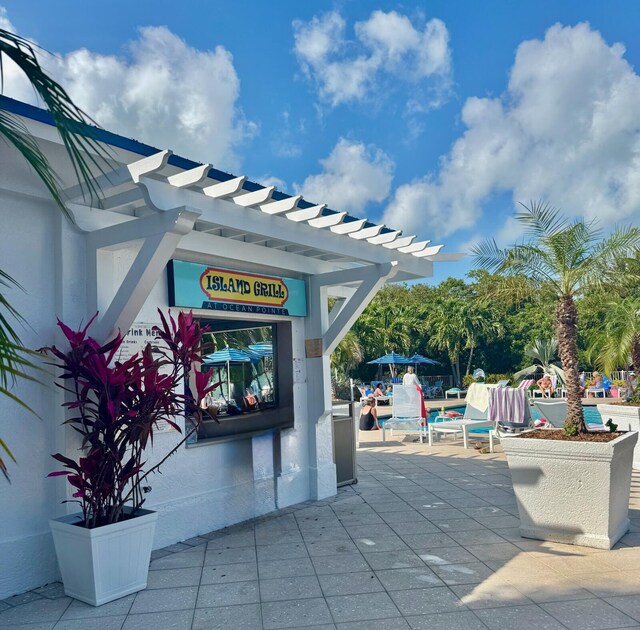 view of community featuring a pergola and a patio