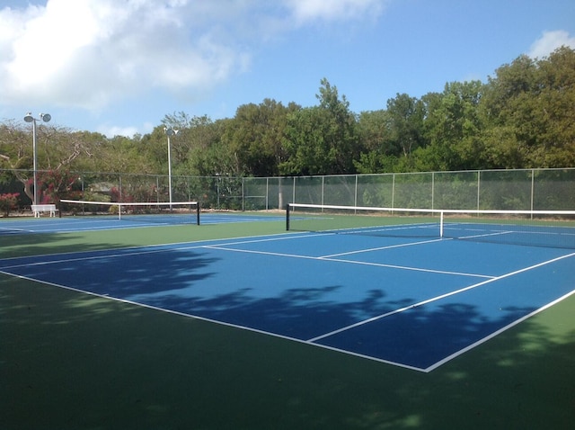 view of tennis court with fence