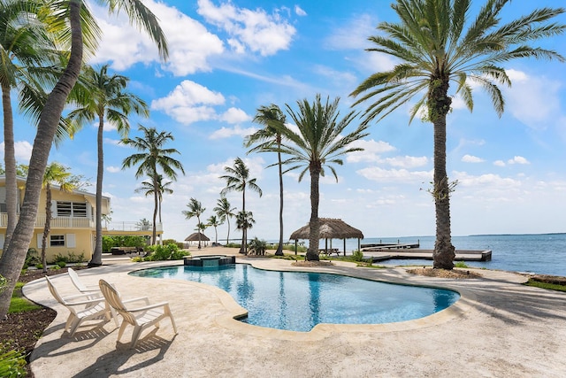 view of pool featuring a water view, a patio, and a gazebo