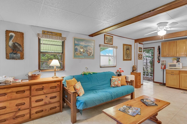 living room with light tile patterned floors, plenty of natural light, and ceiling fan