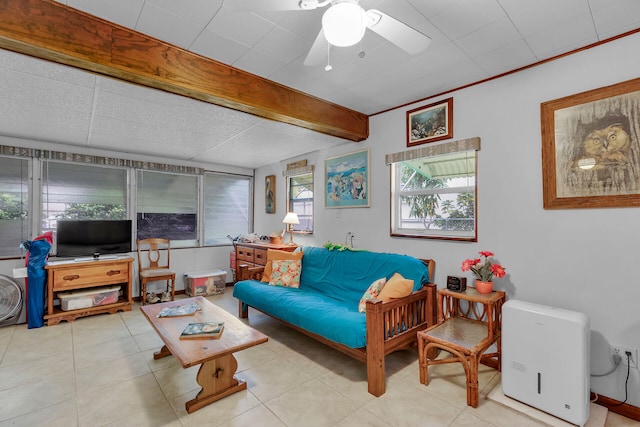 living area with beamed ceiling and a ceiling fan