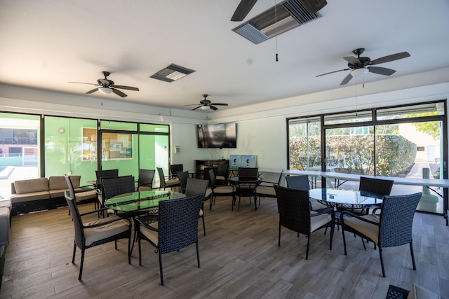 9812 Windward Ave, Key Largo, FL 33037 - dining room featuring wood finished floors, plenty of natural light, and ceiling fan