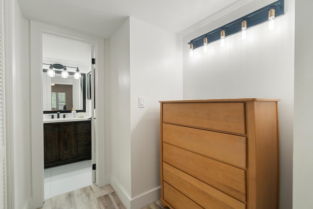 9812 Windward Ave, Key Largo, FL 33037 - bathroom featuring wood finished floors and vanity