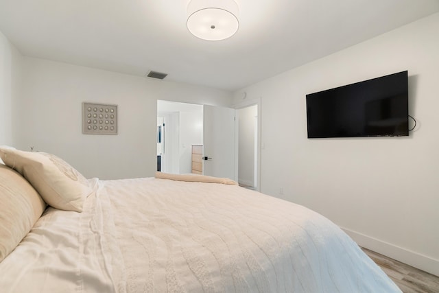 9812 Windward Ave, Key Largo, FL 33037 - bedroom featuring wood finished floors and baseboards