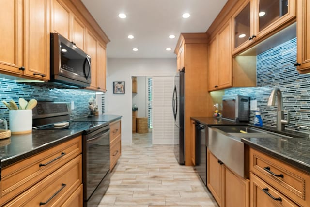 9812 Windward Ave, Key Largo, FL 33037 - kitchen with black appliances, tasteful backsplash, recessed lighting, light wood finished floors, and dark stone countertops