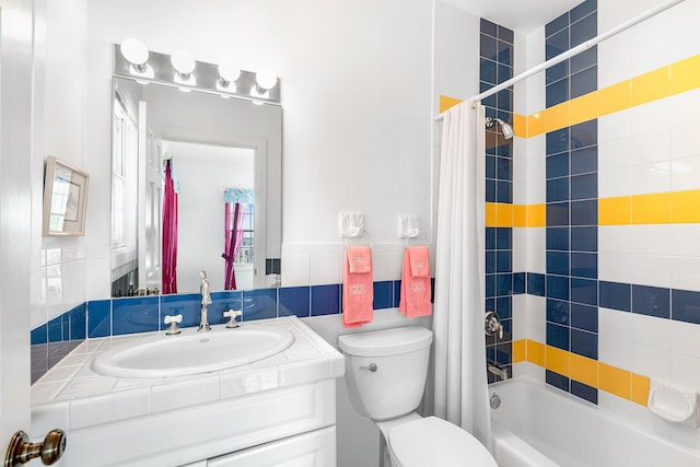 full bathroom with vanity, shower / bath combo, tile walls, and toilet