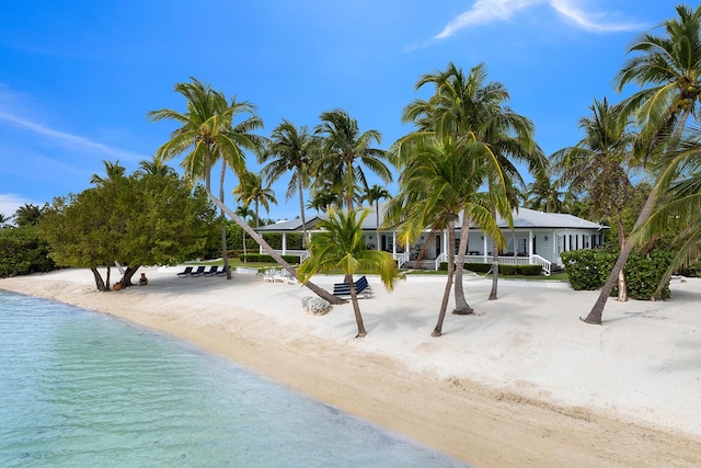 view of pool featuring a view of the beach and a water view