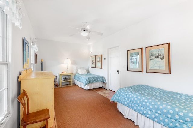 bedroom with ceiling fan and light colored carpet