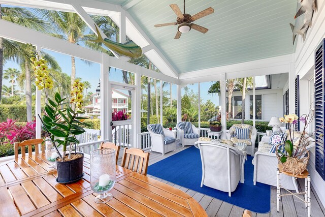 sunroom / solarium featuring plenty of natural light, lofted ceiling, and ceiling fan