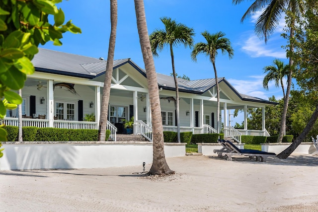 view of front of home with french doors, ceiling fan, and covered porch