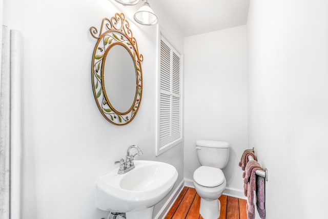 bathroom with sink, hardwood / wood-style floors, and toilet