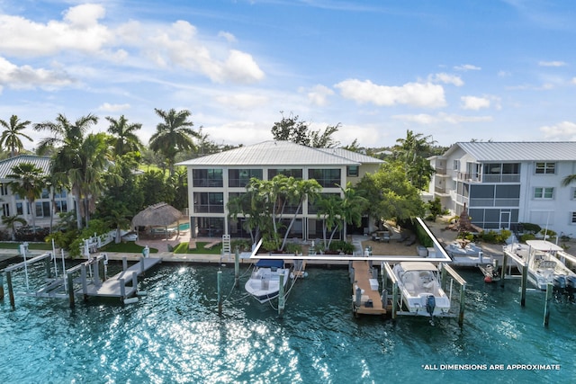 view of pool featuring a water view, a dock, and a sunroom