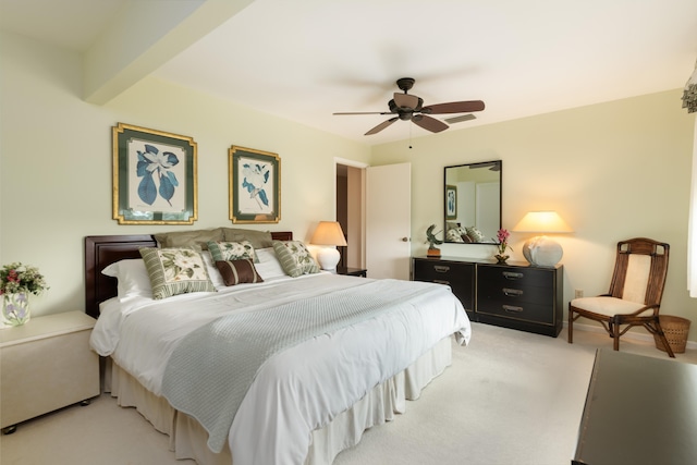 carpeted bedroom with ceiling fan and beamed ceiling