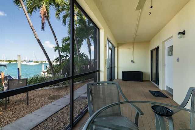 sunroom / solarium featuring a water view