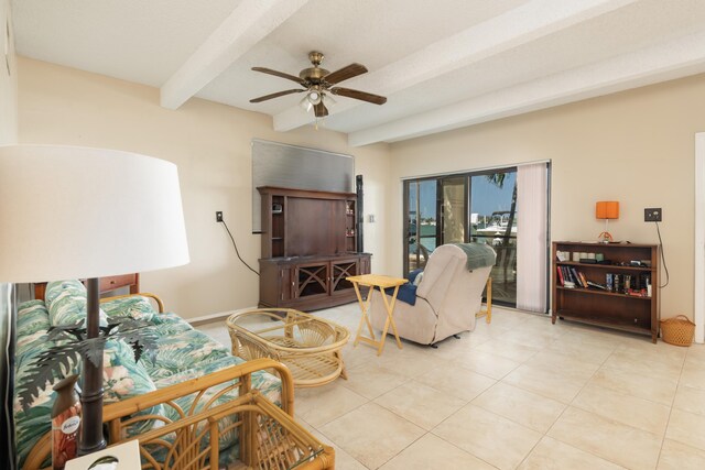 tiled living room with ceiling fan and beamed ceiling