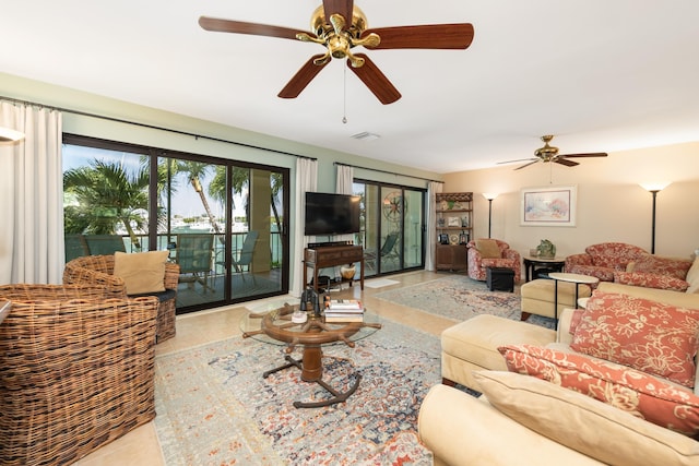 living room featuring light tile patterned floors and ceiling fan