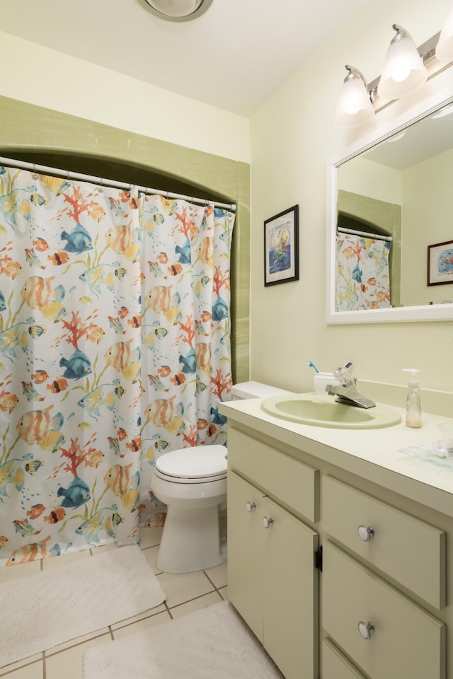 bathroom with a shower with curtain, tile patterned floors, toilet, and vanity