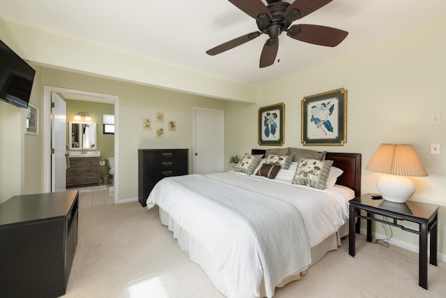 carpeted bedroom featuring ceiling fan and ensuite bathroom