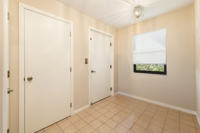 empty room with light tile patterned flooring