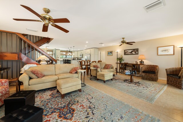 tiled living room with ceiling fan