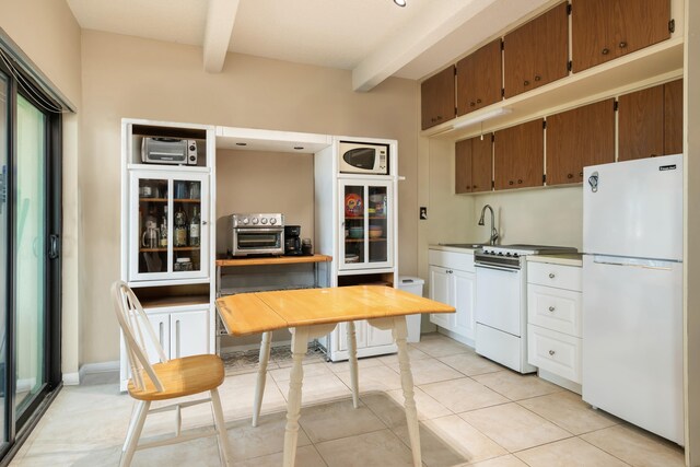 kitchen featuring light tile patterned flooring, sink, white appliances, dark brown cabinetry, and beam ceiling