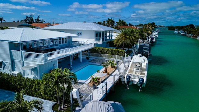 exterior space featuring a fenced in pool, a patio, a water view, fence, and stairs