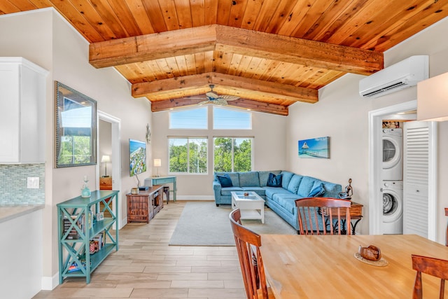 living area featuring vaulted ceiling with beams, wooden ceiling, light wood-style flooring, an AC wall unit, and stacked washing maching and dryer