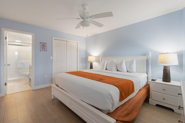 bedroom with connected bathroom, light hardwood / wood-style flooring, ceiling fan, and a closet