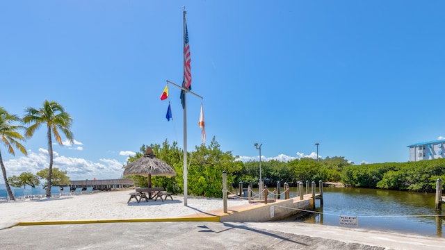 view of home's community featuring a water view and volleyball court