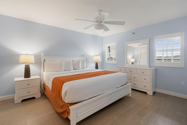 bedroom with light hardwood / wood-style floors and ceiling fan