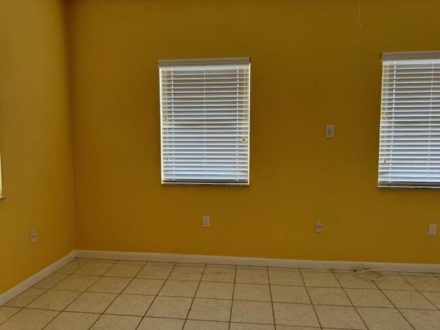 empty room with light tile patterned floors