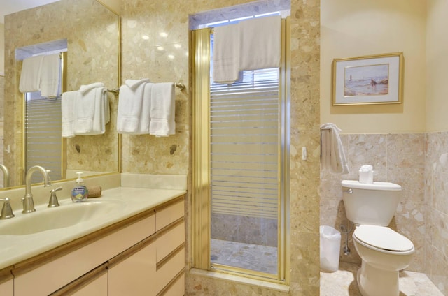 bathroom featuring tile walls, vanity, and toilet