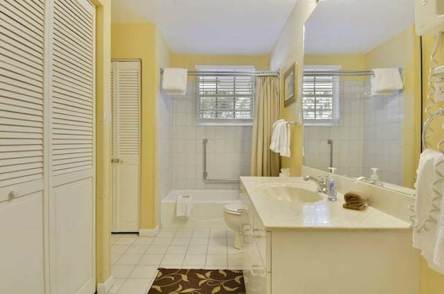 full bathroom with vanity, tiled shower / bath, tile patterned floors, and toilet