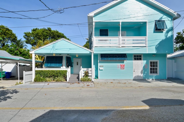 view of front facade featuring a balcony and a porch