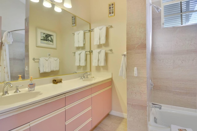 bathroom with vanity and tiled shower / bath