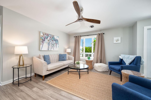 living room featuring ceiling fan and light hardwood / wood-style floors