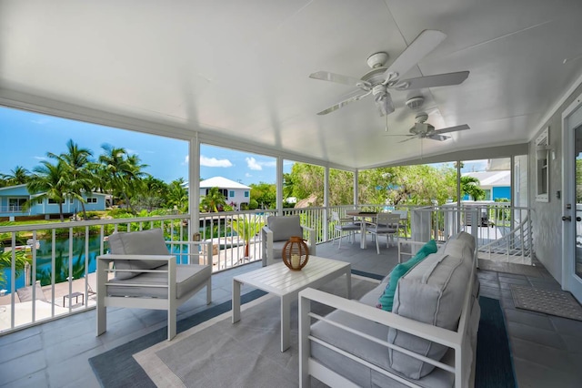 sunroom / solarium with a water view