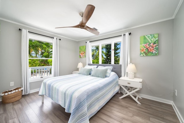 bedroom with ceiling fan, ornamental molding, and wood-type flooring