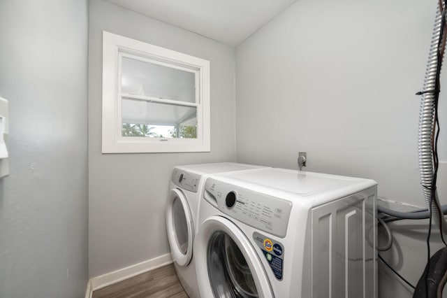 laundry room featuring dark wood-type flooring and washing machine and clothes dryer