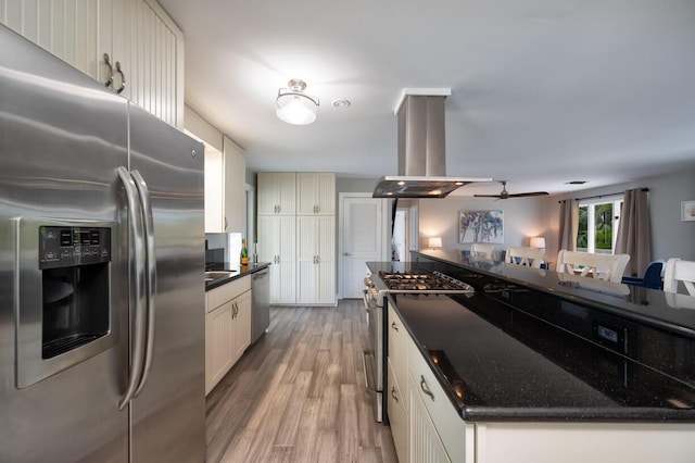 kitchen featuring stainless steel appliances, island exhaust hood, white cabinets, and light wood-type flooring