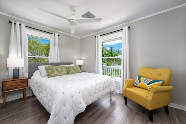 bedroom with crown molding, dark wood-type flooring, and ceiling fan