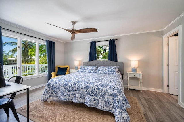 bedroom featuring multiple windows, crown molding, and hardwood / wood-style floors