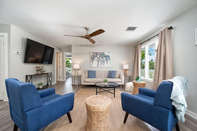 living room with hardwood / wood-style flooring and ceiling fan