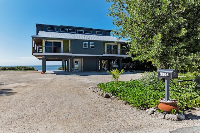 22542 Jolly Roger Dr, Cudjoe, FL 33042 - coastal home featuring dirt driveway, metal roof, a carport, and a balcony